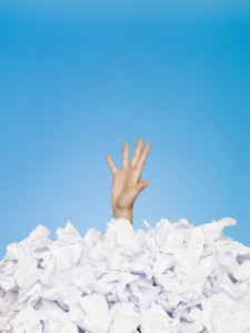Human buried in papers on blue background